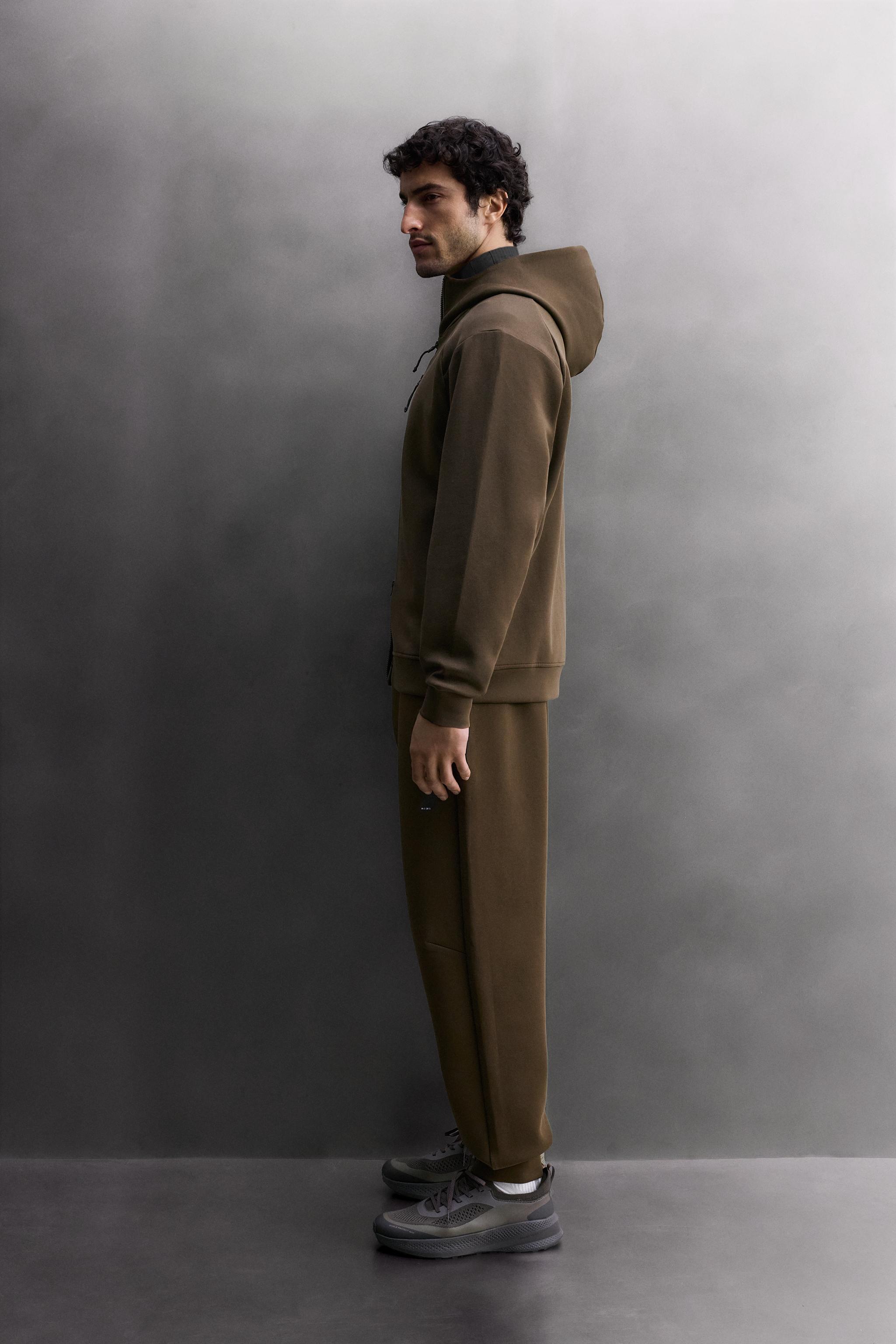 SWEAT TECHNIQUE ZIPPÉ À CAPUCHE